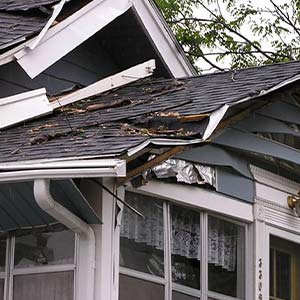 Close up of a residential roof damaged by a storm