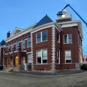 Top view of a large commercial building with a flat, white roof